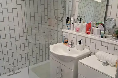 a white bathroom with a sink and a shower at Apartment - Sleeps 4 - Pet friendly - Parking in Troon