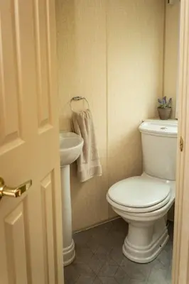 a bathroom with a toilet and a sink at Treetops in Lamplugh