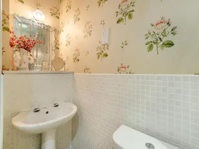 a white bathroom with a sink and a mirror at Rose Cottage - Lpd in Ireby