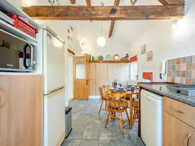 a kitchen with a table and a dining room at Hollow Creek Cottage - 28012 in Rockcliffe