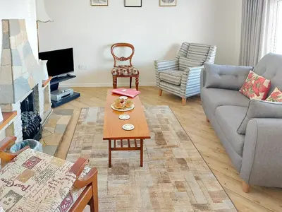 a living room with a couch and a coffee table at Briar Bank Bungalow in Cockermouth
