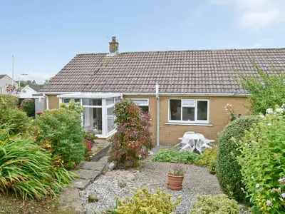 a small house with a garden in front of it at Briar Bank Bungalow in Cockermouth