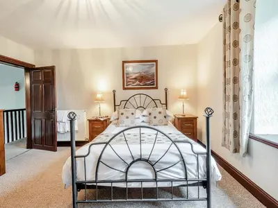 a bedroom with a bed and a window at Halls Bank Farm in Plumbland