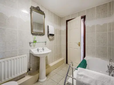 a bathroom with a sink and a bath tub at Berwyn Bank in Gilcrux