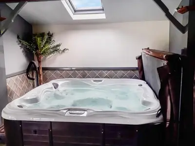a bath tub in a bathroom with a skylight at Berwyn Bank in Gilcrux