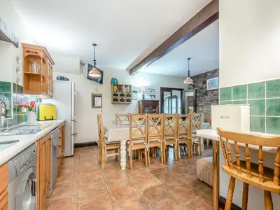 a kitchen and dining room with a table and chairs at Berwyn Bank in Gilcrux