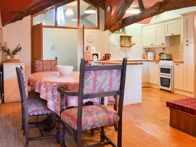 a kitchen and dining room with a table and chairs at Birkerthwaite Cottage-W41479 in Eskdale