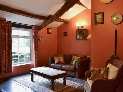 a living room with a couch and a table at Birkerthwaite Barn-W41478 in Eskdale