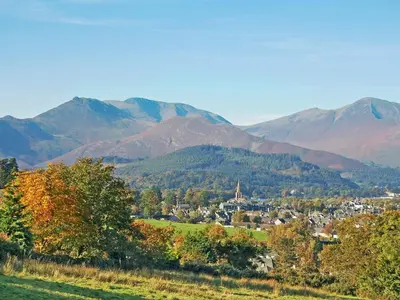 a town in a valley with mountains in the background at The Coach House in Thirlmere