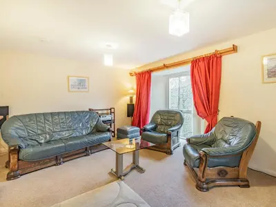 a living room with a couch and two chairs at Galena in Glenridding
