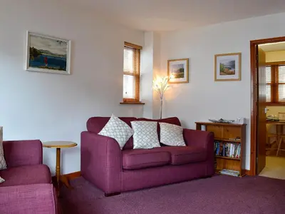 a living room with a purple couch and a table at Inglewood - 15288 in Keswick