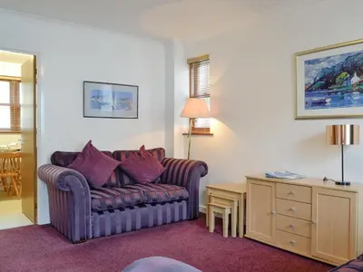 a living room with a couch and a table at Glenwood - 18630 in Keswick