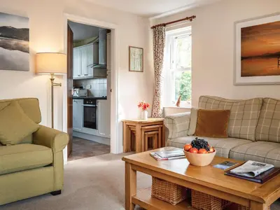 a living room with two couches and a coffee table at Flat 4 in Keswick
