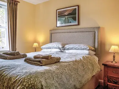 a bedroom with a bed with two towels on it at Flat 4 in Keswick