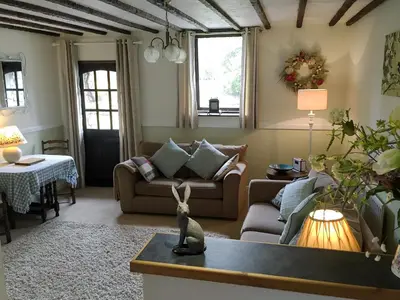 a living room with a couch and a table at Little Beck in Troutbeck
