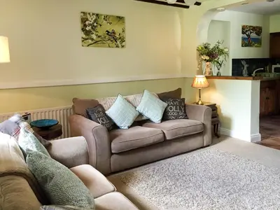a living room with a couch with pillows on it at Little Beck in Troutbeck