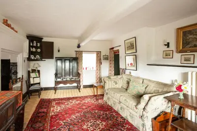 a living room with a couch and a rug at Johnby Hall in Penrith