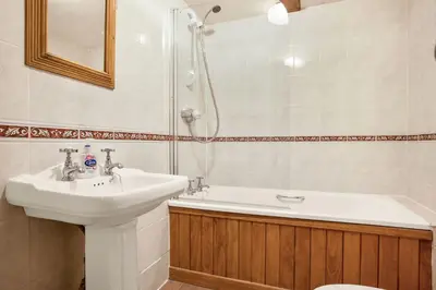 a bathroom with a sink and a shower at The Coppermines Mountain Cottages - Sawyers, Carpenters, Pelton Wheel, Sleeps 18 in Coniston