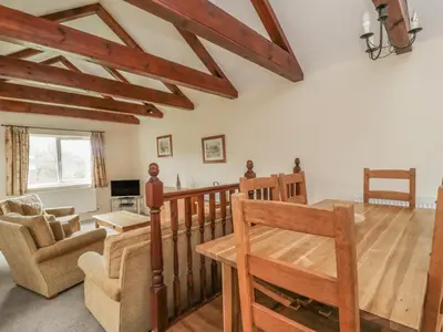 a living room with wooden floors and wooden beams at Whitbarrow 24 in Penrith