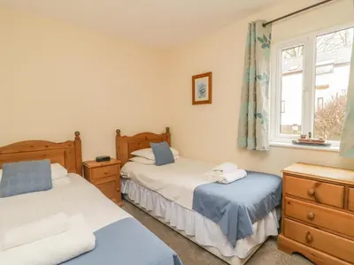 a bedroom with two beds and a window at Whitbarrow 24 in Penrith
