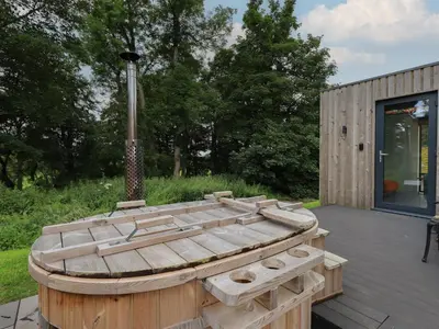 a wooden tub sitting on top of a deck at Brow Wood Cabin in Penrith