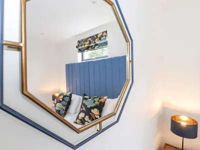 a mirror hanging on a wall in a room at Bluebell Cabin in Penrith