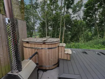 two wooden barrels sitting on top of a deck at Bluebell Cabin in Penrith