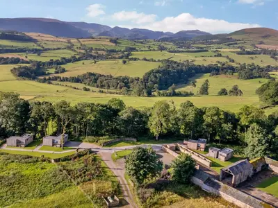 an aerial view of a farm in the hills at Bluebell Cabin in Penrith