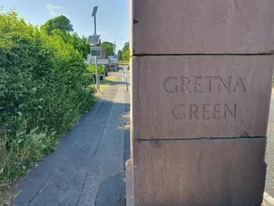 a sign on a wall that reads greenia green at Kirkcroft Guest House in Gretna