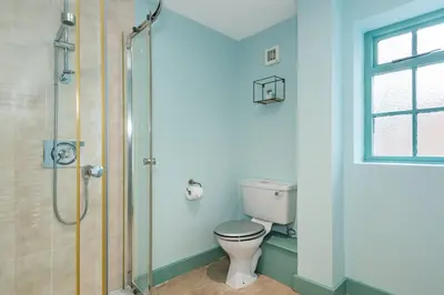 a bathroom with a toilet and a shower at The Queens in Carlisle