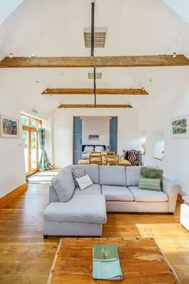 a living room with a couch and a table at The Haybarn in Dundrennan