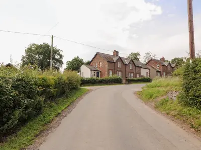 an empty road in a village with houses at Rose Bank Cottage in Carlisle