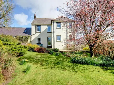 a house with a garden in front of it at The Cottage in Girvan