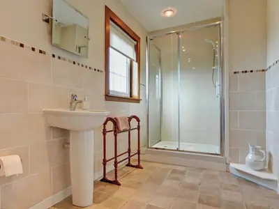 a bathroom with a sink and a shower at The Cottage in Girvan