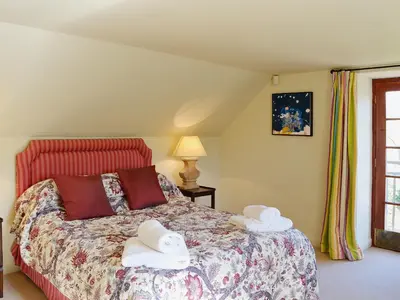 a bedroom with a bed with towels on it at Arkland Mill in Corsock