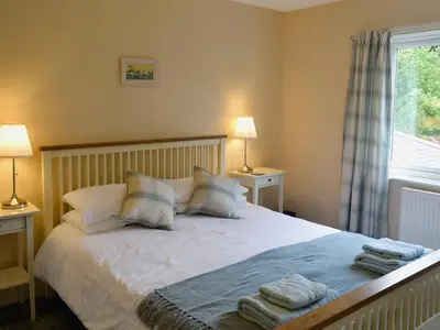 a bedroom with a bed with towels on it at Burnbank in Kirkgunzeon