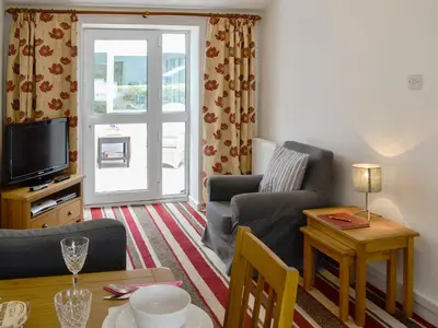 a living room with a couch and a tv and a table at Barnhill Bothy in Moffat