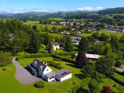 an aerial view of a house on a green field at Mountain Cross in Gatehouse of Fleet