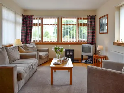 a living room with a couch and a tv at Peace in Whauphill
