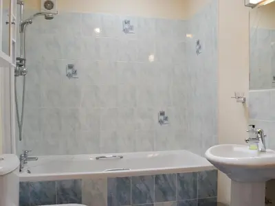 a bathroom with a sink and a tub and a toilet at Peace in Whauphill