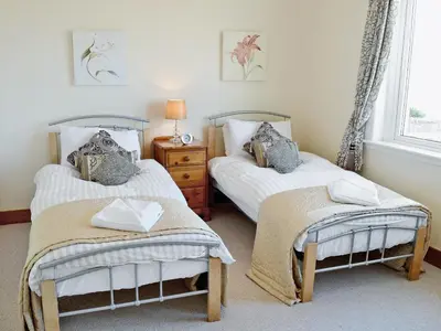 a bedroom with two beds and a window at Winloma in Port William