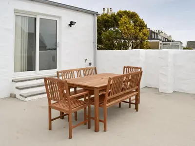 a wooden table and two chairs on a patio at Sea-Esta - 28175 in Port William