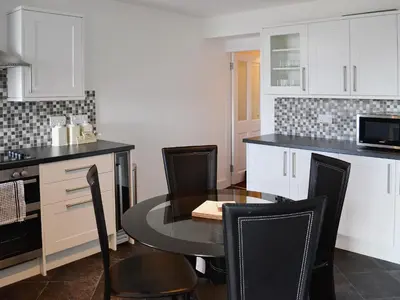 a kitchen with a table and chairs in a kitchen at Sea-Esta - 28175 in Port William