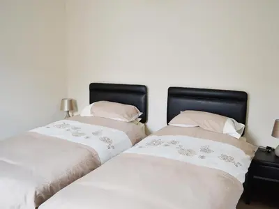 two beds sitting next to each other in a bedroom at Sea-Esta - 28175 in Port William