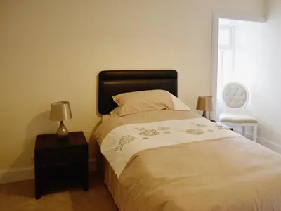a bedroom with a bed and a nightstand with two lamps at Sea-Esta - 28175 in Port William