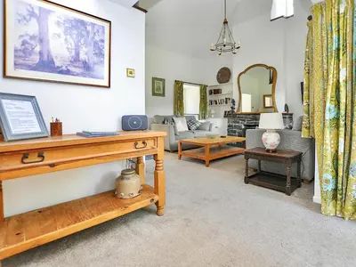 a living room with a couch and a table at Holly Cottage - 28140 in Boreland of Colvend