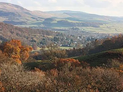 a view of a valley with trees and mountains at Rose Cottage - 28176 in Fairgirth