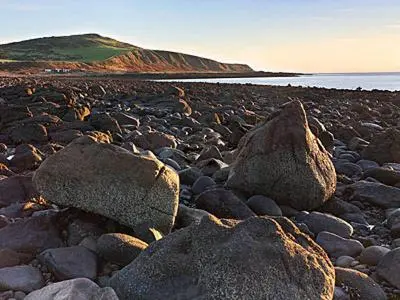 a group of rocks on a rocky beach at Myrtle Cottage - 28177 in Fairgirth