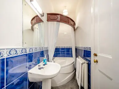 a bathroom with a sink and a toilet and a mirror at Braefield in Portpatrick