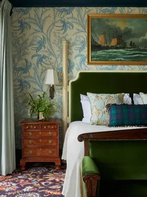 a bedroom with a bed and a painting of a ship at Marine Troon in Troon
